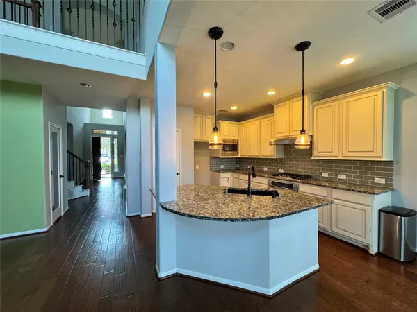 a kitchen with center island a sink stainless steel appliances and cabinets