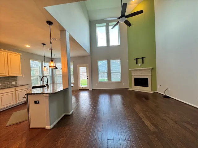 a view of a kitchen with cabinets and wooden floor