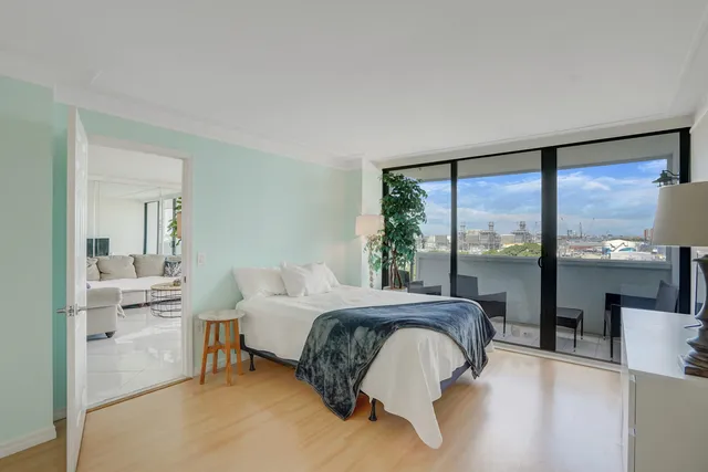 a bedroom with a bed and large window