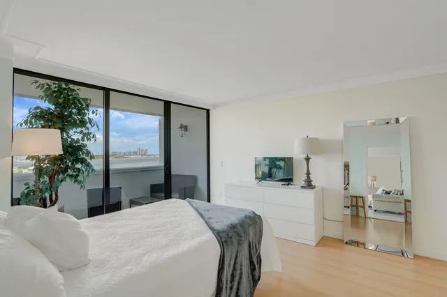 a bedroom with a large bed and a large window