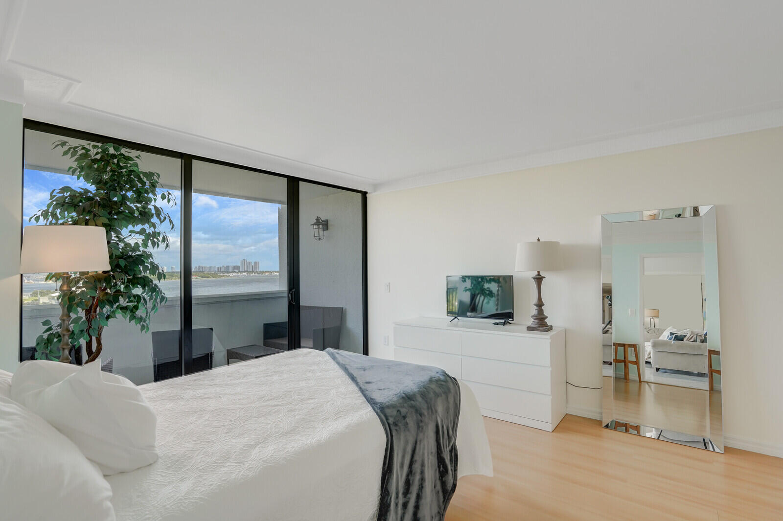 5600 North Flagler Drive, Unit 907 West Palm Beach, FL 33407 - Photo 14 of 48 a bedroom with a large bed and a large window