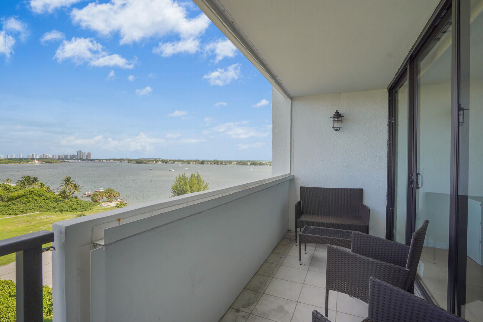 5600 North Flagler Drive, Unit 907 West Palm Beach, FL 33407 - Photo 19 of 48 a terrace with a bench and lake view