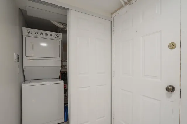a large white kitchen with granite countertop a sink