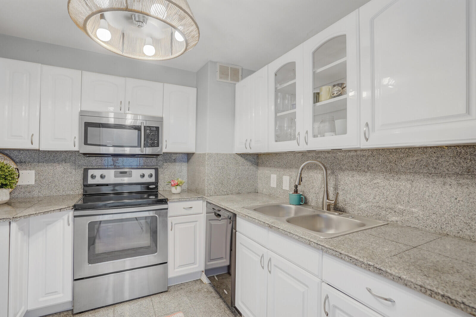 5600 North Flagler Drive, Unit 907 West Palm Beach, FL 33407 - Photo 4 of 48 a kitchen with appliances cabinets and a sink