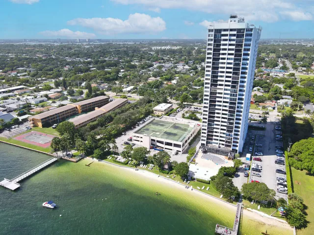 an aerial view of a house with outdoor space and lake view
