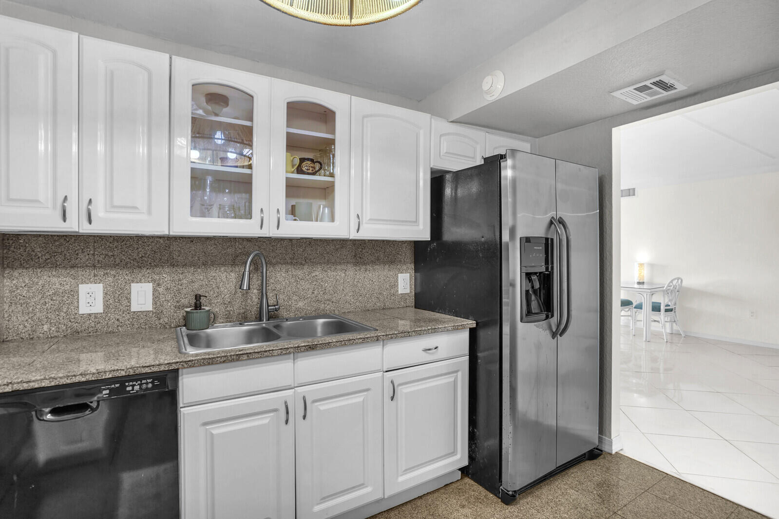 5600 North Flagler Drive, Unit 907 West Palm Beach, FL 33407 - Photo 6 of 48 a kitchen with stainless steel appliances granite countertop a refrigerator and a sink