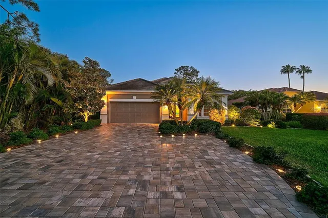 a front view of a house with a yard and a garage