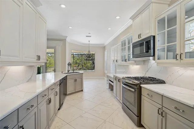 a kitchen with stainless steel appliances granite countertop a stove and a sink