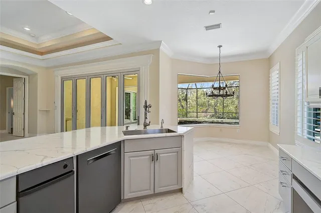 a large white kitchen with a large window