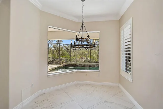 a dining room with a window and chandelier