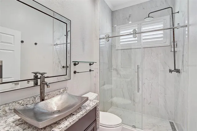 a view of a hallway with a chandelier fan and windows