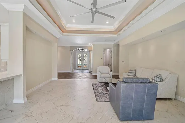 a living room with furniture and a chandelier
