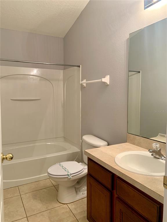 7131 Harmony Square Drive South, Unit 3 Harmony, FL 34773 - Photo 14 of 16 a bathroom with a sink a toilet and shower