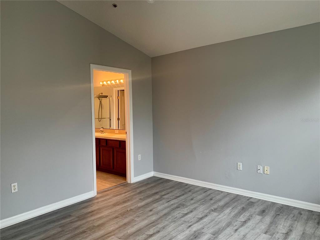 7131 Harmony Square Drive South, Unit 3 Harmony, FL 34773 - Photo 8 of 16 a view of an empty room with wooden floor and a window