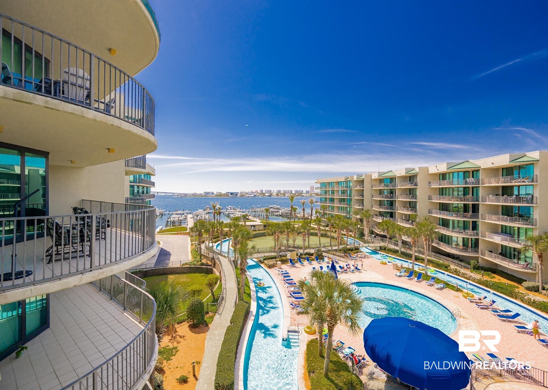 27580 Canal Road, Unit 1429 Orange Beach, AL 36561 - Photo 17 of 45 Community pool with a balcony, a water view, view of marina, and a patio area