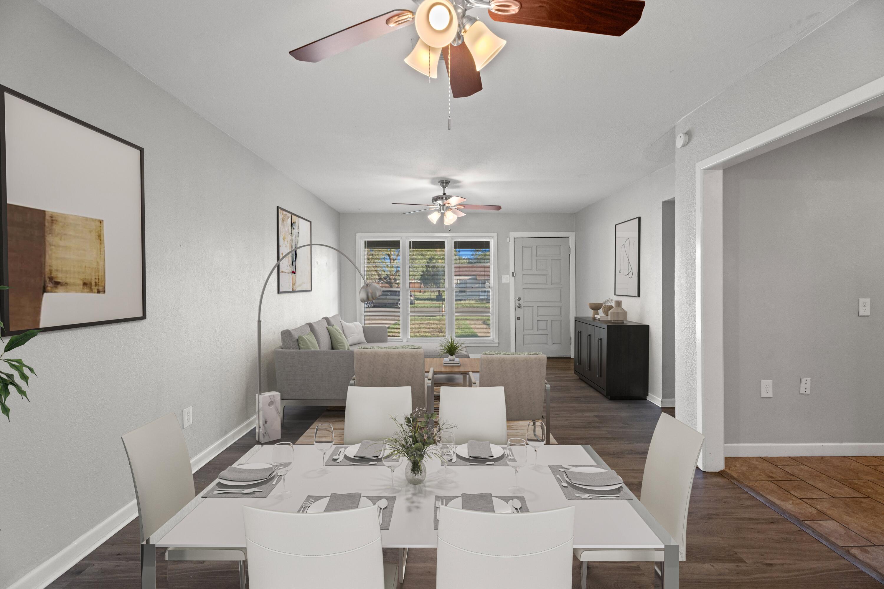 5105 38th Street Lubbock, TX 79414 - Photo 3 of 13 a living room with furniture a chandelier and a dining table
