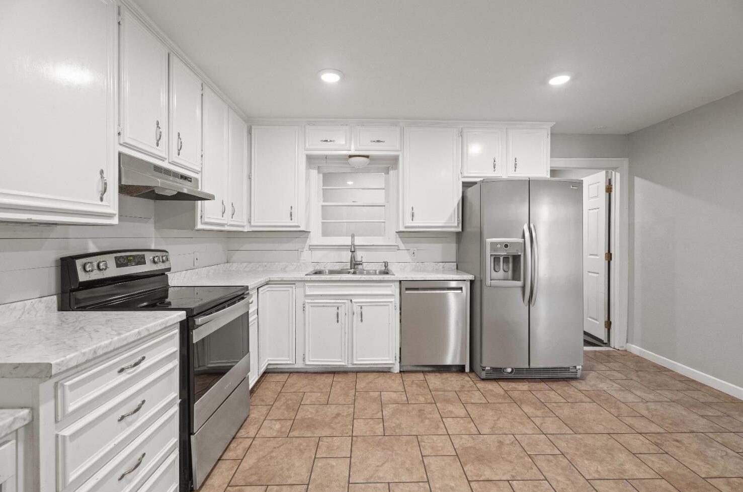 5105 38th Street Lubbock, TX 79414 - Photo 4 of 13 a kitchen with stainless steel appliances granite countertop a refrigerator sink and stove