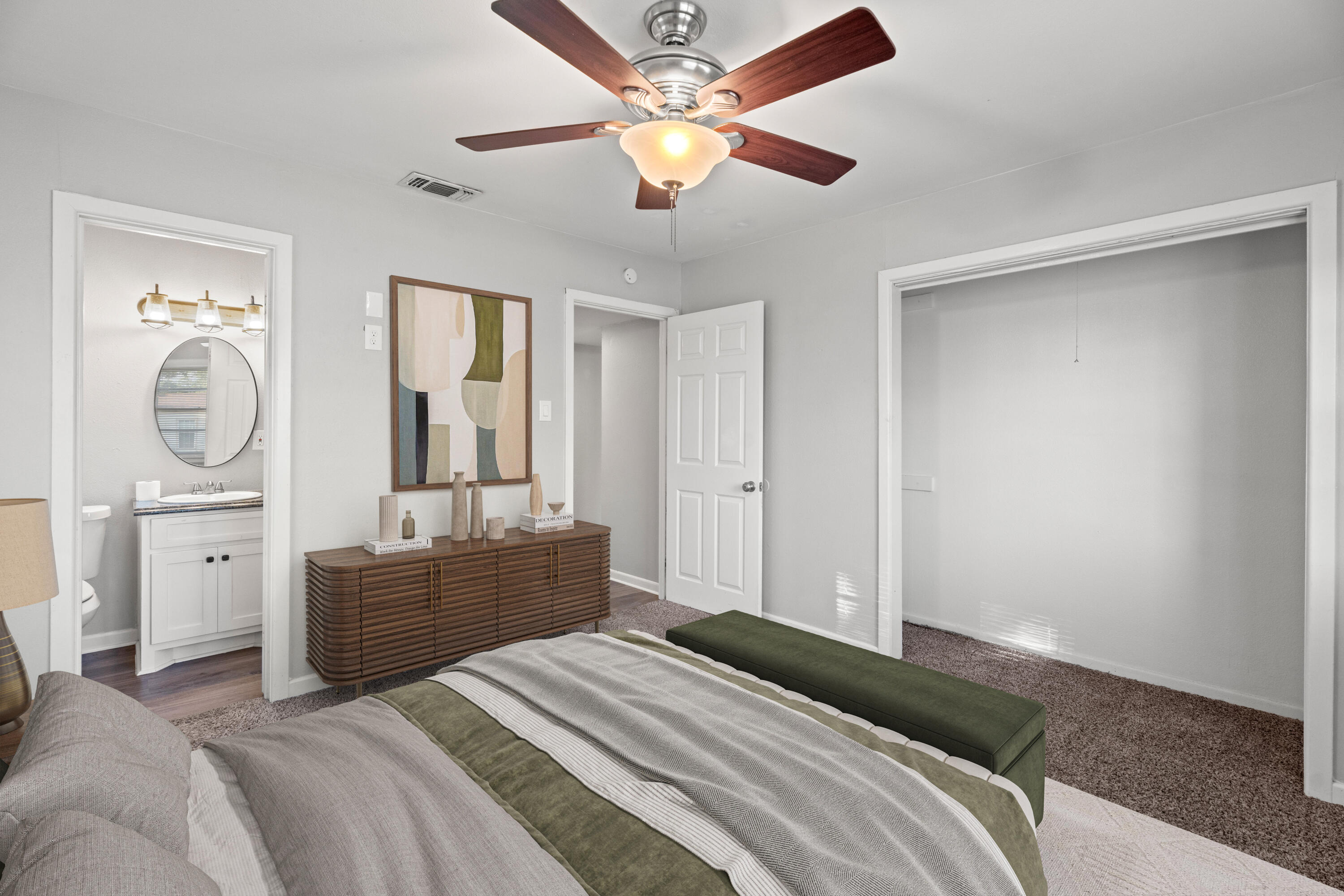 5105 38th Street Lubbock, TX 79414 - Photo 6 of 13 a bedroom with a bed a chandelier and dresser