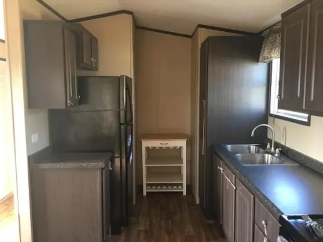 a kitchen with a refrigerator and a sink