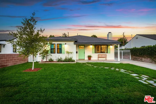 a front view of house with yard outdoor seating and green space