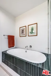 a view of a backyard with table and chairs and a barbeque