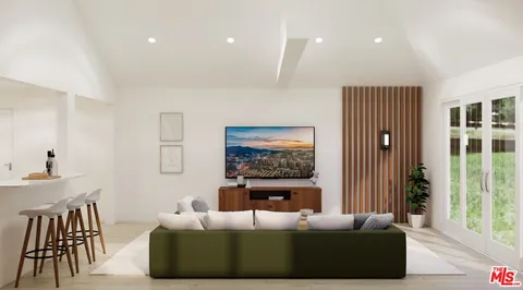 a living room with furniture a large window and a flat screen tv