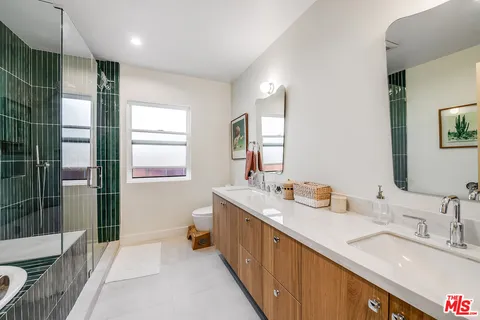 a spacious bathroom with double vanity and a bathtub