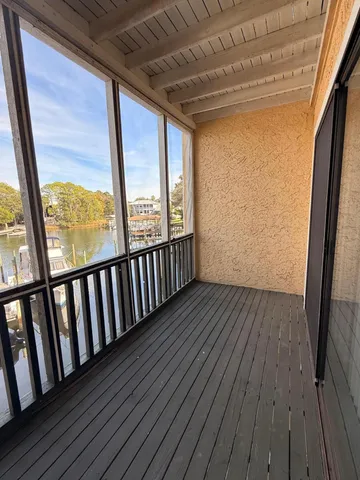a kitchen with a sink a microwave a refrigerator and cabinets