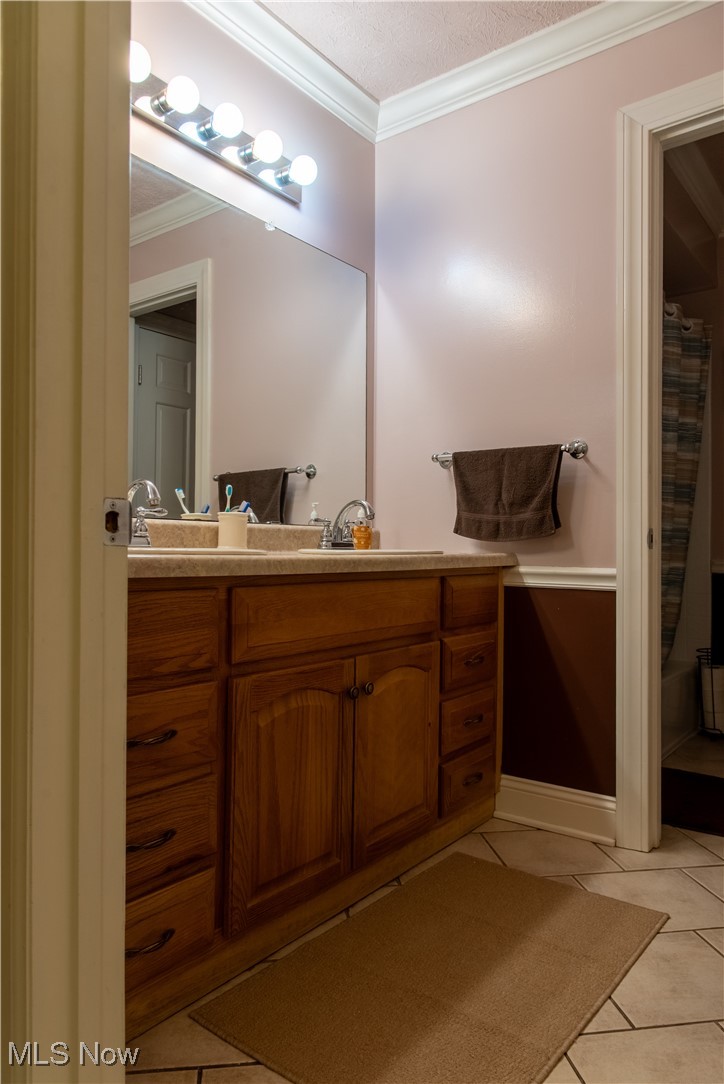 7969 Bricker Road Northwest Clinton, OH 44216 - Photo 18 of 23 Bathroom featuring tile floors, and double vanity