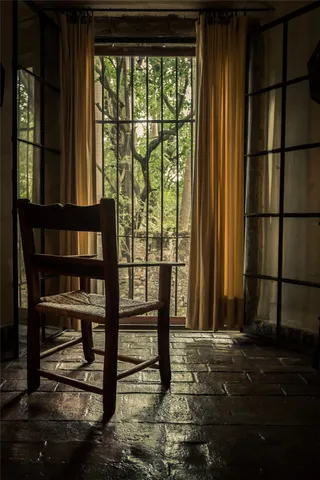 a living room with fireplace furniture and a large window