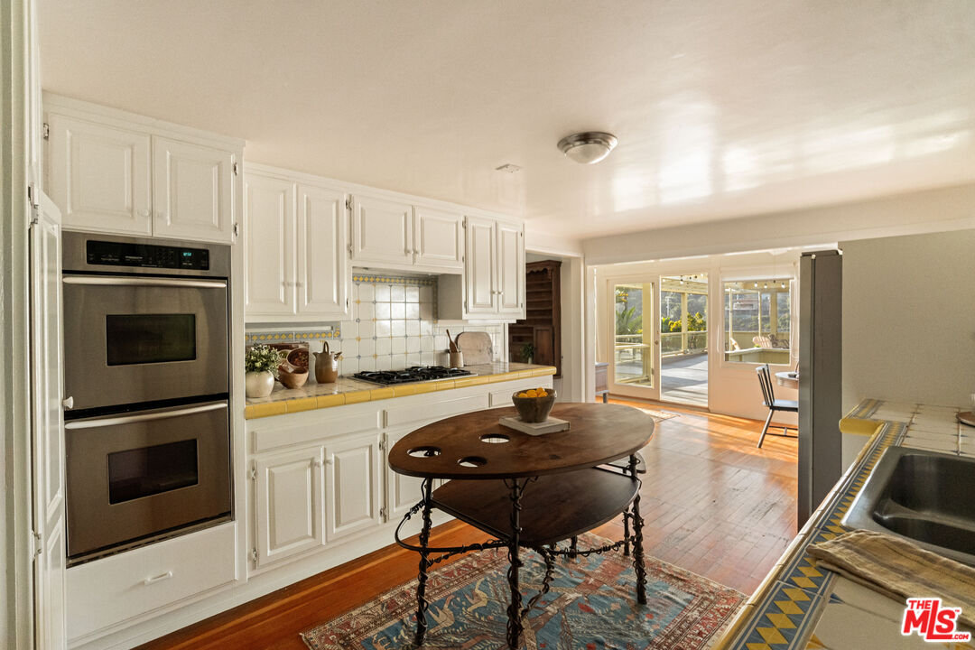 237 Mabery Road Santa Monica, CA 90402 - Photo 12 of 43 a kitchen with a stove a refrigerator and a stove top oven