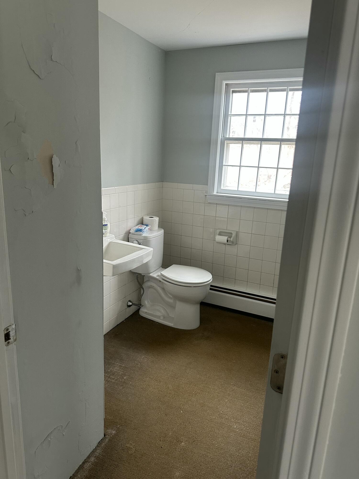 33 Old Colony Road Harwich, MA 02645 - Photo 12 of 16 a bathroom with a toilet sink and window