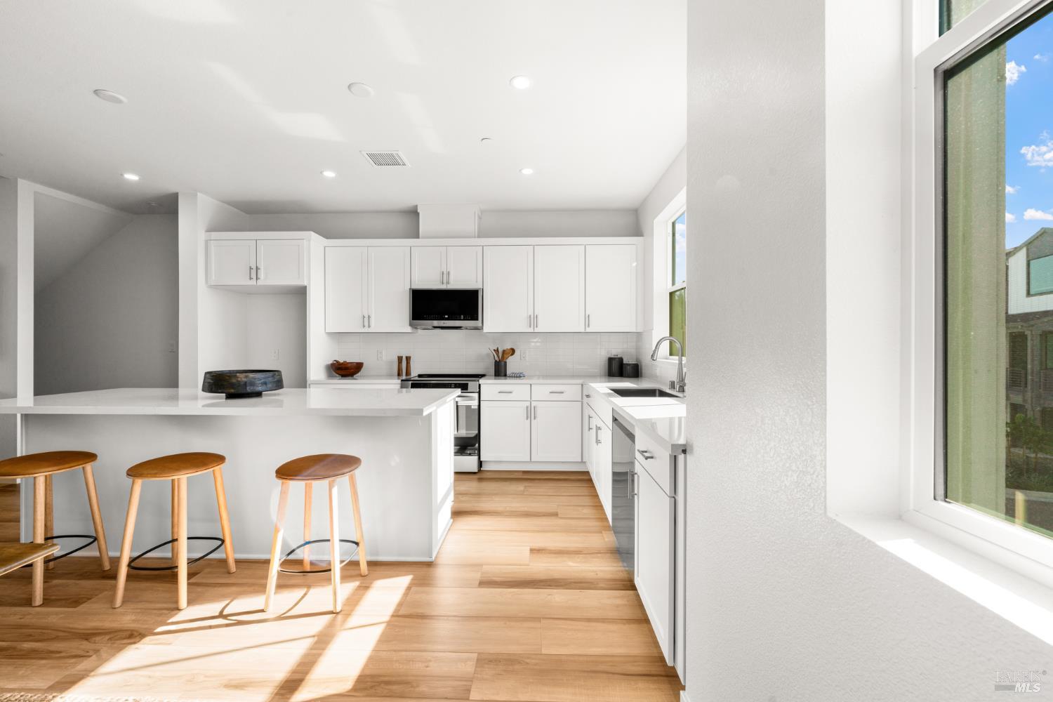 1460 Waterside Lane Rohnert Park, CA 94928 - Photo 8 of 21 a kitchen with white cabinets and sink