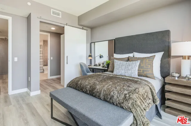 a bedroom with a bed and a night stand