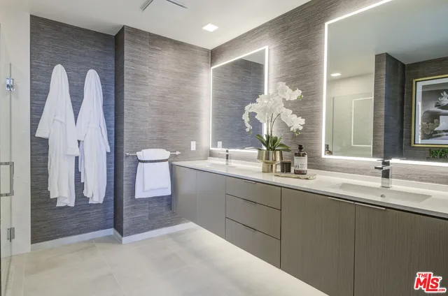 a bathroom with a double vanity sink and a mirror