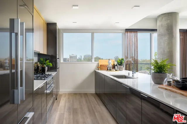 a large white kitchen with a large window