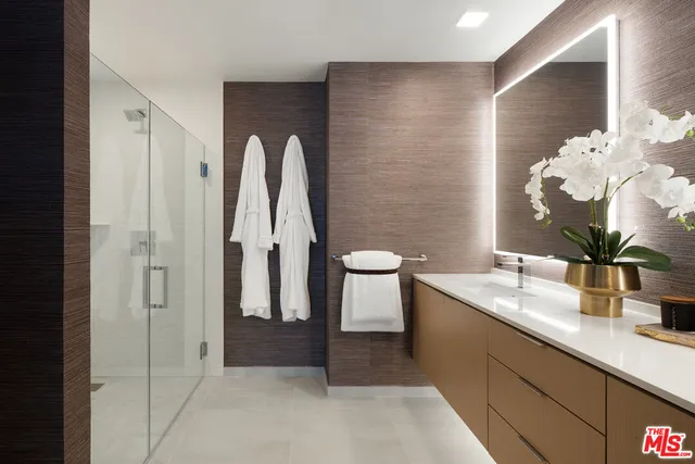 a bathroom with a granite countertop sink a toilet and shower