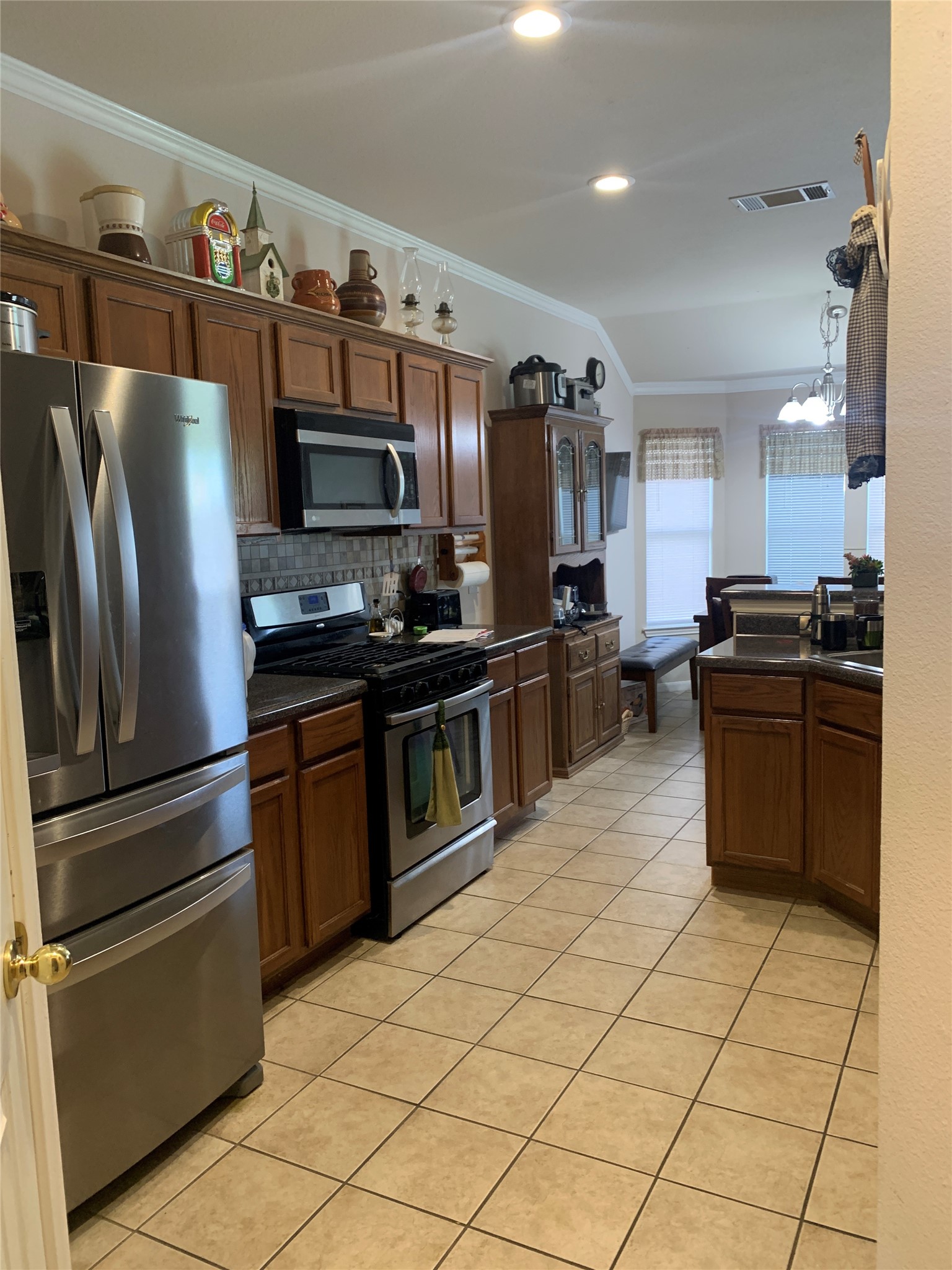 150 Elmer Cove Kyle, TX 78640 - Photo 4 of 11 a kitchen with stainless steel appliances a refrigerator sink and microwave