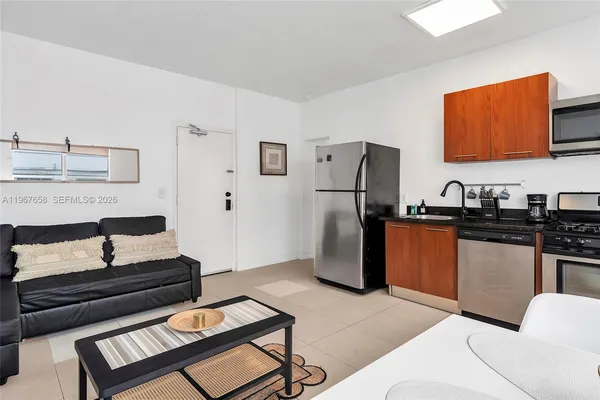 a kitchen with stainless steel appliances granite countertop a refrigerator and a stove top oven