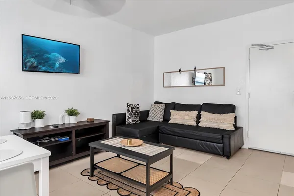 a living room with furniture and a dining table