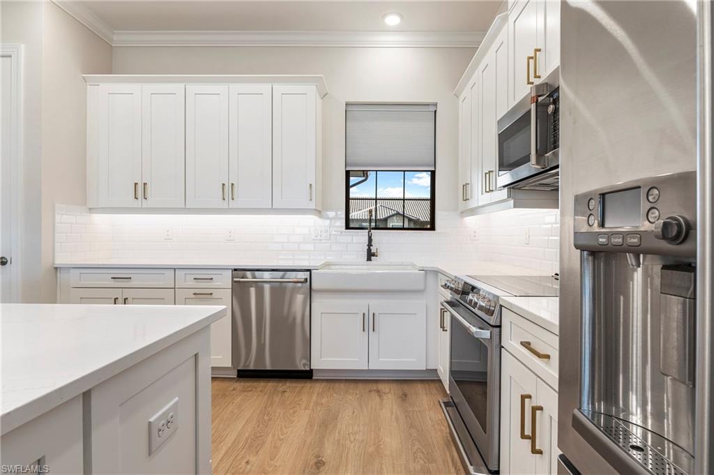 15328 Lucerna Street, Unit 202 Naples, FL 34114 - Photo 13 of 32 a kitchen with stainless steel appliances granite countertop a sink stove and refrigerator