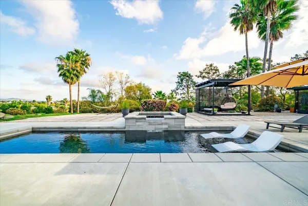 a front view of house with yard outdoor seating and barbeque oven