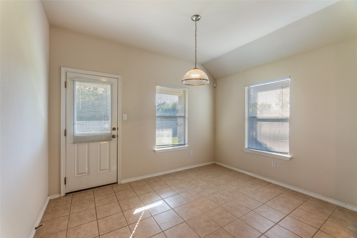 200 Falcon Lane Leander, TX 78641 - Photo 8 of 20 Doorway to outside with tile patterned floors and lofted ceiling