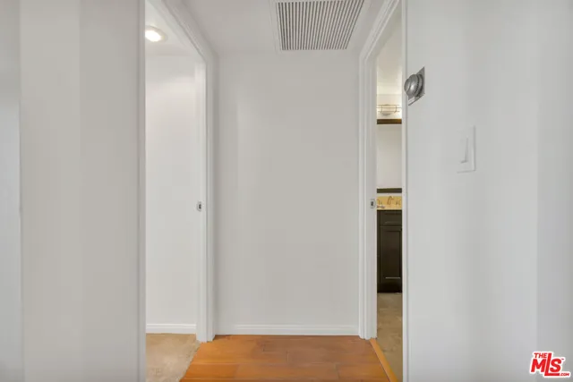 a kitchen with a refrigerator a table and chairs