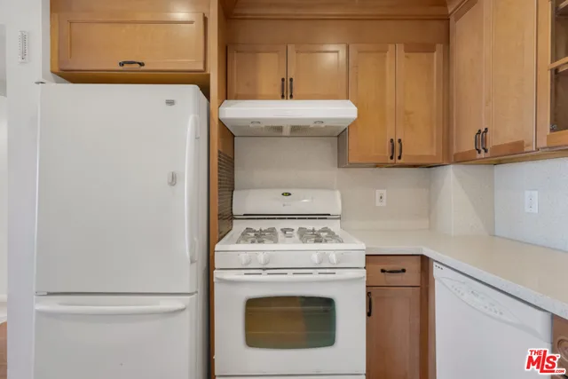 a kitchen with stainless steel appliances granite countertop a sink and cabinets
