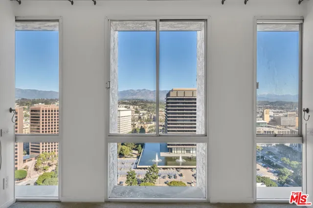 a view of a hallway with a window and front door