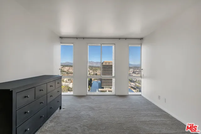 a walk in closet with empty racks