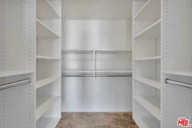 a bathroom with a double vanity sink toilet mirror and shower