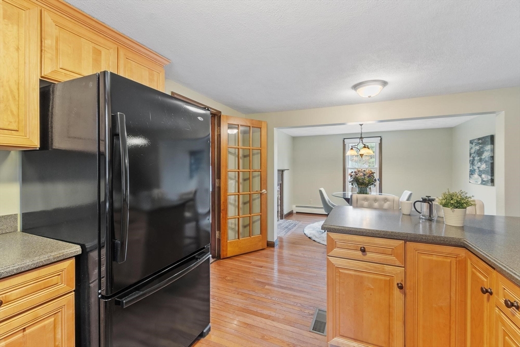 61 Beaver Road Reading, MA 01867 - Photo 11 of 39 a kitchen with stainless steel appliances granite countertop a refrigerator and a sink