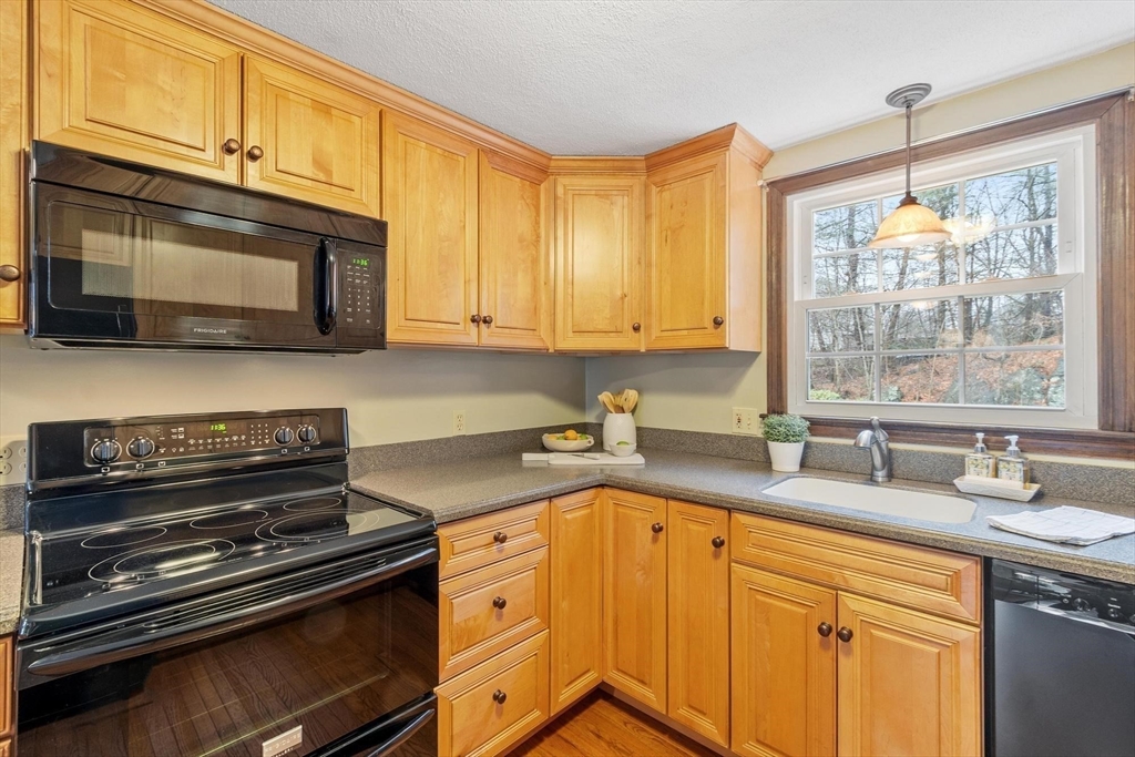 61 Beaver Road Reading, MA 01867 - Photo 12 of 39 a kitchen with granite countertop cabinets stainless steel appliances a sink and window